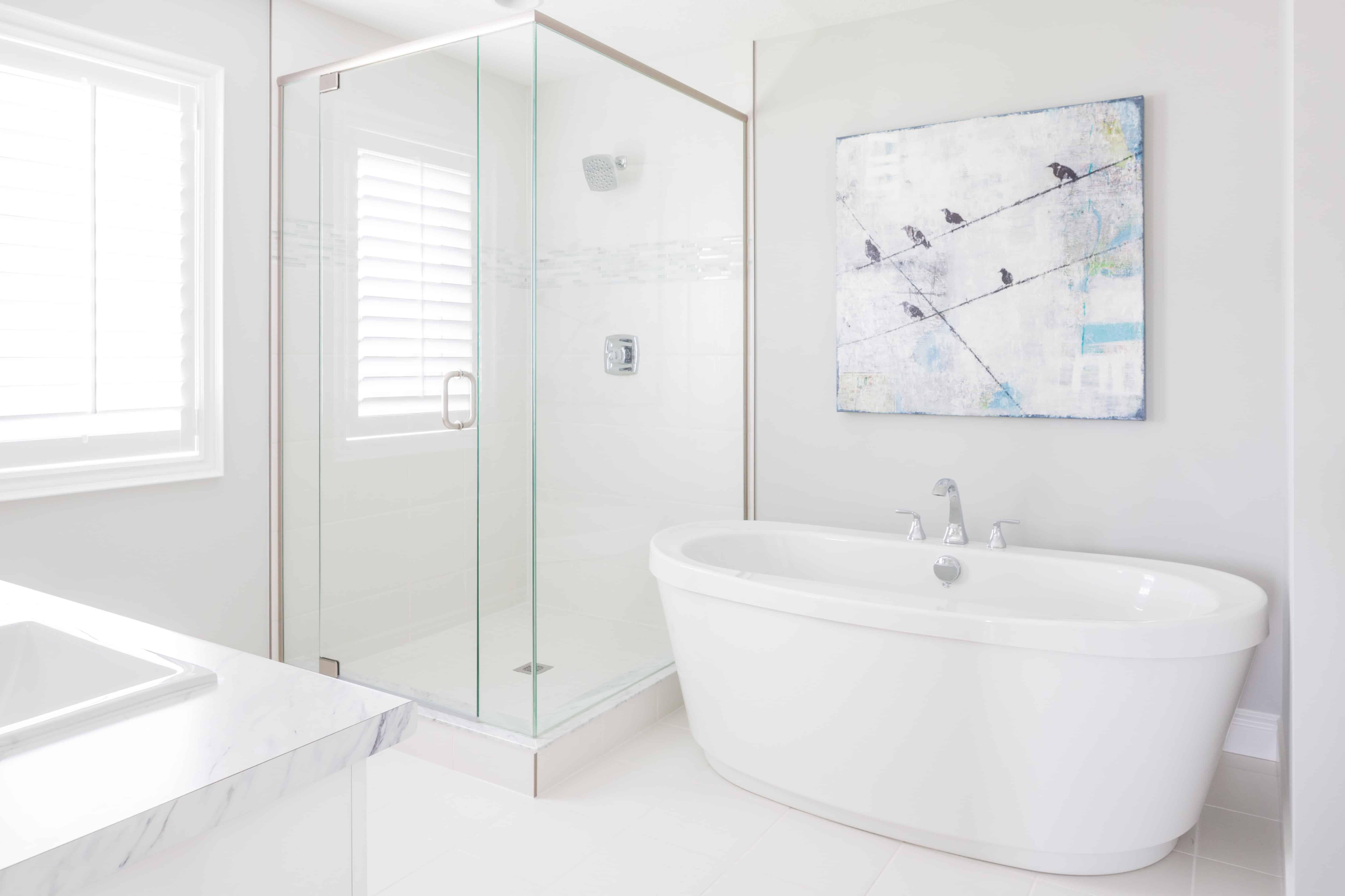 white bathroom with porcelain tub and shower